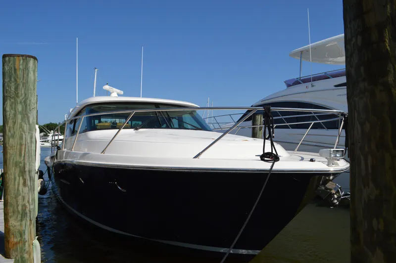 Andros Yacht Photos Pics 2016 Tiara Yachts C44 Coupe docked at marina under clear blue sky.