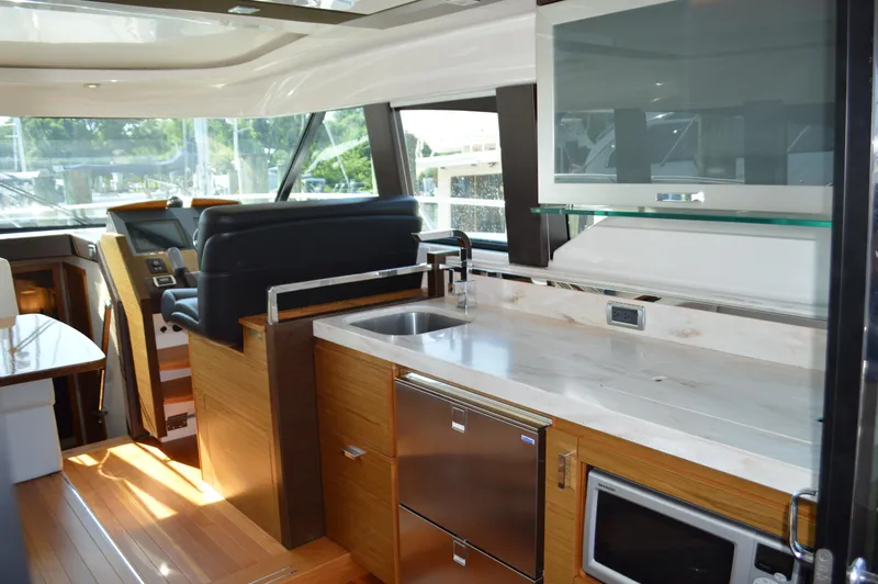 Andros Yacht Photos Pics Luxurious interior of 2016 Tiara Yachts C44 Coupe with modern kitchen amenities.