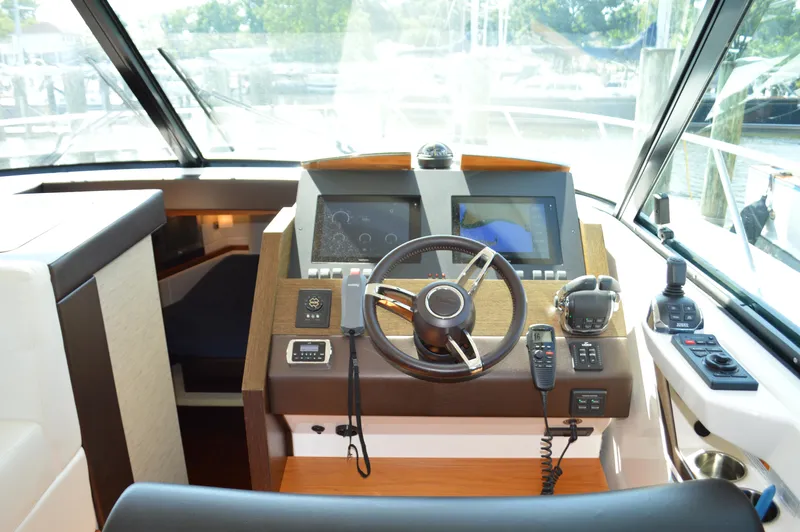 Andros Yacht Photos Pics 2016 Tiara Yachts C44 Coupe helm with modern navigation controls and steering wheel.