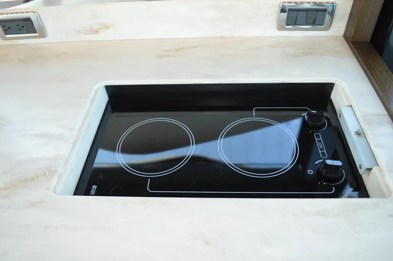 Andros Yacht Photos Pics Built-in electric stove on 2016 Tiara Yachts C44 Coupe, featuring dual burners.