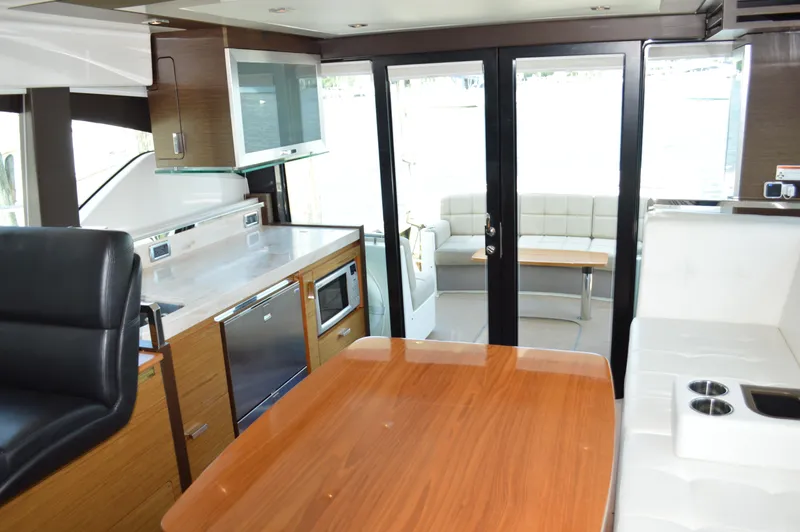 Andros Yacht Photos Pics Interior of 2016 Tiara Yachts C44 Coupe, featuring modern kitchen and seating area.