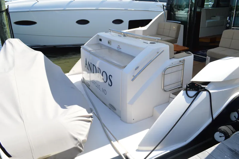 Andros Yacht Photos Pics 2016 Tiara Yachts C44 Coupe, docked with covered equipment, featuring sleek design and spacious seating.