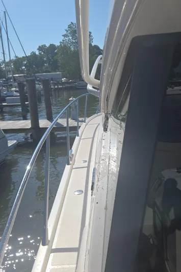 Andros Yacht Photos Pics 2016 Tiara Yachts C44 Coupe docked at marina, side view with railing and water.