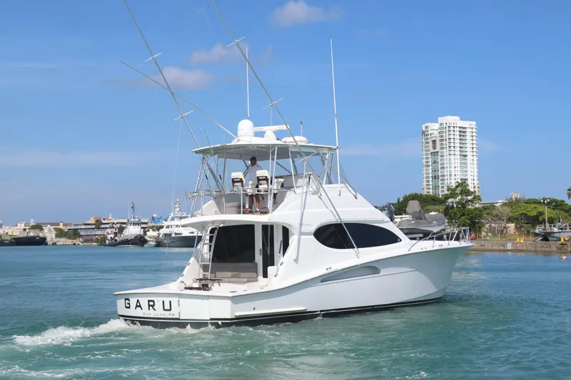  Yacht Photos Pics 2004 Hatteras 54 Convertible yacht cruising in a harbor with clear skies.