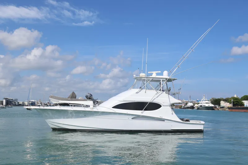  Yacht Photos Pics 2004 Hatteras 54 Convertible yacht on calm water under blue sky.