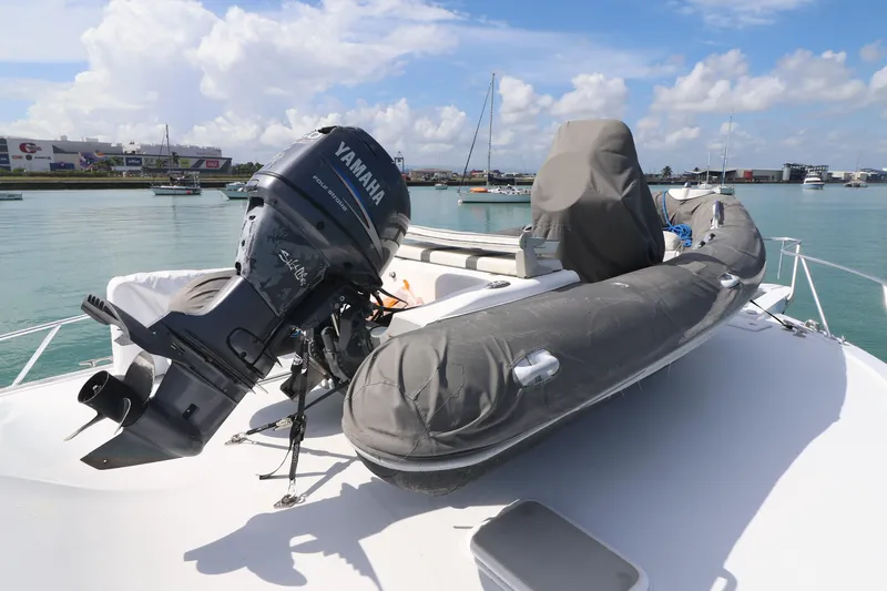  Yacht Photos Pics 2004 Hatteras 54 Convertible yacht with Yamaha outboard motor and inflatable boat on deck.
