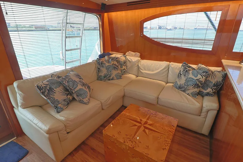  Yacht Photos Pics Luxurious interior of 2004 Hatteras 54 Convertible yacht with plush seating and nautical decor.