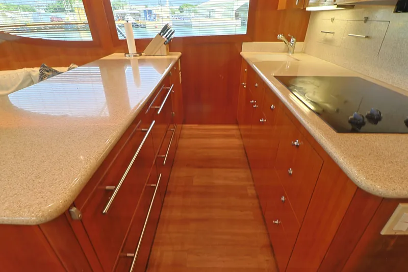  Yacht Photos Pics Luxurious kitchen interior of 2004 Hatteras 54 Convertible yacht with modern appliances.
