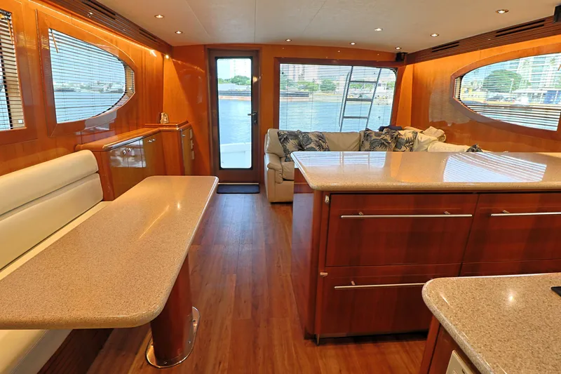  Yacht Photos Pics Luxurious interior of 2004 Hatteras 54 Convertible yacht with elegant wood finishes.