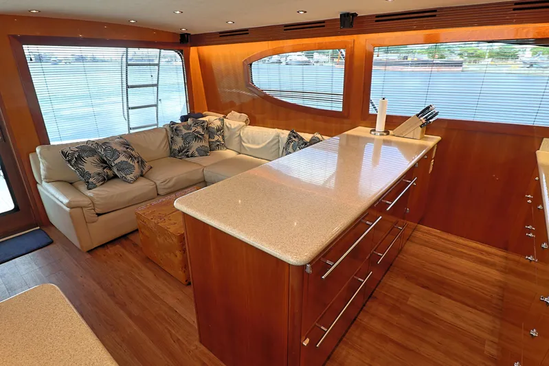  Yacht Photos Pics Luxurious interior of 2004 Hatteras 54 Convertible yacht with modern furnishings and large windows.
