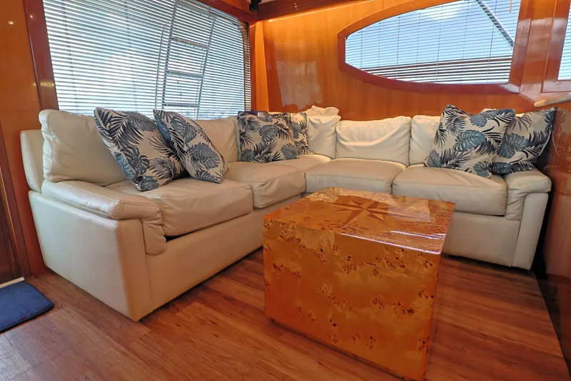  Yacht Photos Pics Luxurious interior of 2004 Hatteras 54 Convertible yacht with plush seating and decorative pillows.