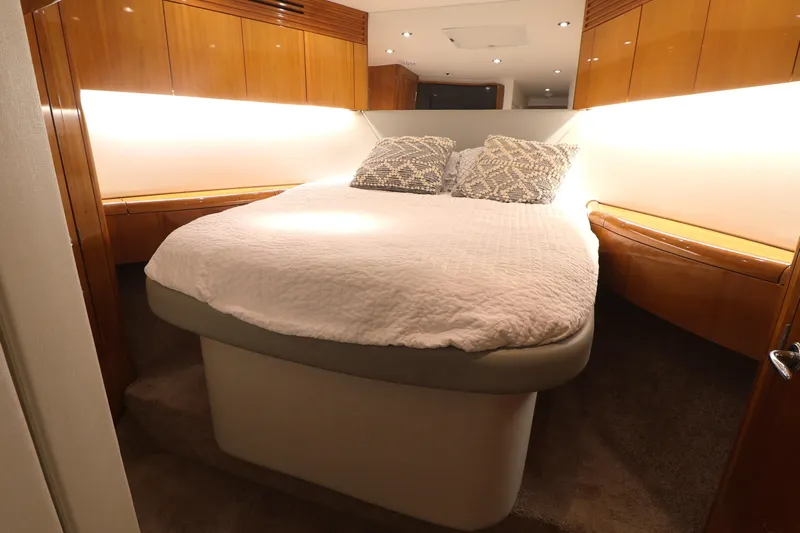  Yacht Photos Pics Luxurious bedroom interior of 2004 Hatteras 54 Convertible yacht with cozy bedding.