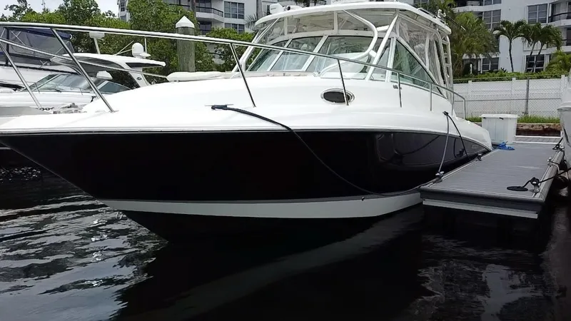 Yacht Photos Pics 2014 Wellcraft 340 Coastal boat docked at marina, sleek design, white and black exterior.