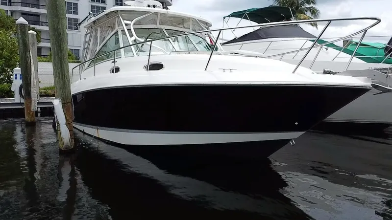  Yacht Photos Pics 2014 Wellcraft 340 Coastal boat docked in marina, side view.