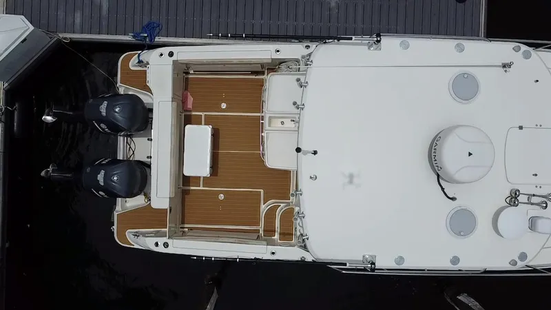  Yacht Photos Pics Aerial view of 2014 Wellcraft 340 Coastal boat docked, featuring twin outboard engines.