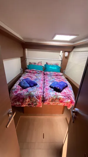  Yacht Photos Pics 2019 Lagoon 50 yacht cabin with colorful bedding and natural light.