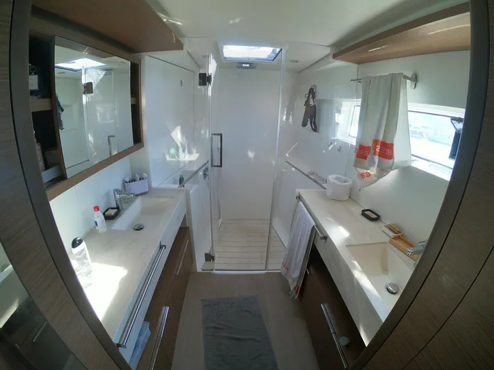  Yacht Photos Pics Luxurious bathroom interior of a 2019 Lagoon 50 catamaran, featuring modern fixtures and ample lighting.