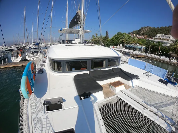  Yacht Photos Pics 2019 Lagoon 50 catamaran docked at marina, featuring spacious deck and netting.