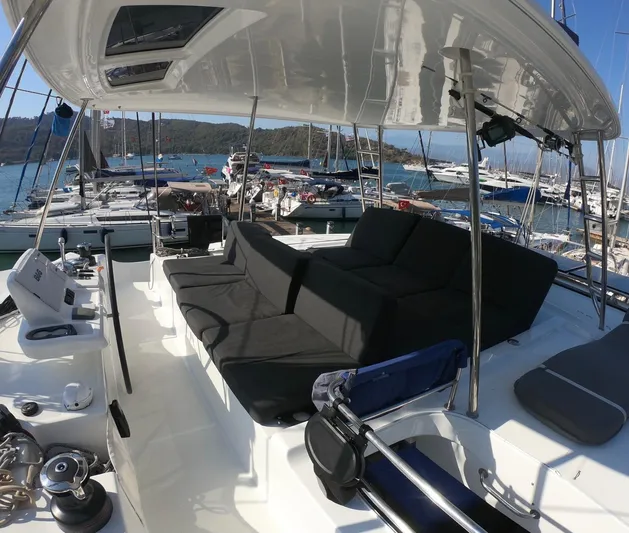  Yacht Photos Pics Luxurious 2019 Lagoon 50 catamaran deck with comfortable seating, docked at a marina.