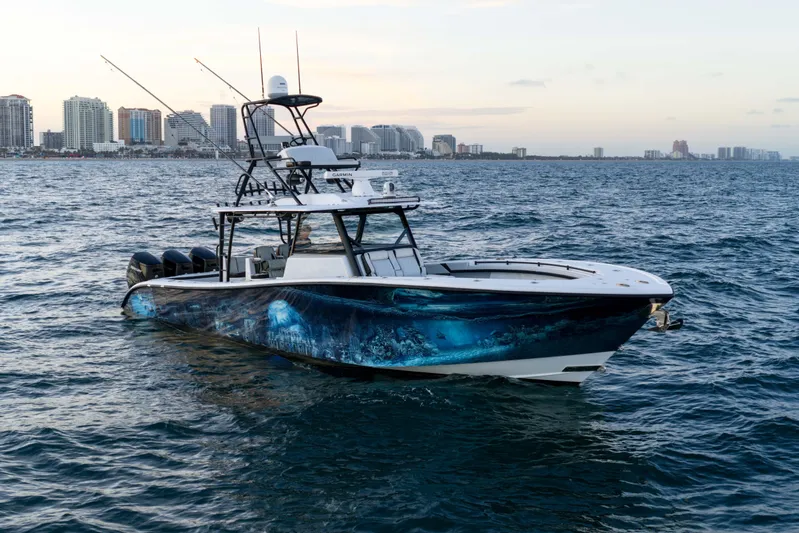  Yacht Photos Pics 2023 Yellowfin 42 Offshore boat on ocean with city skyline background.