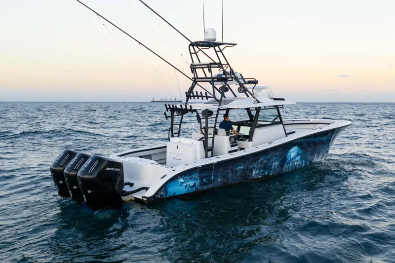  Yacht Photos Pics 2023 Yellowfin 42 Offshore boat on open sea at sunset.