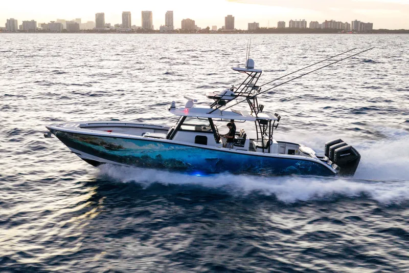  Yacht Photos Pics 2023 Yellowfin 42 Offshore boat cruising on ocean near city skyline.