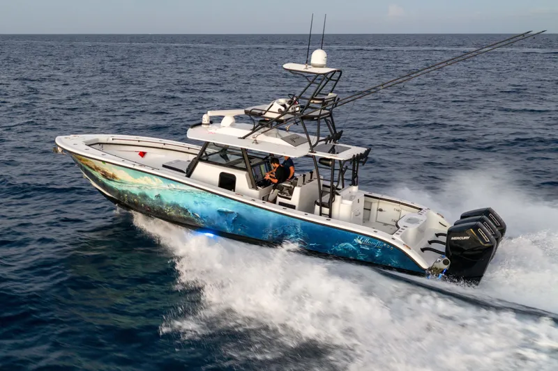  Yacht Photos Pics 2023 Yellowfin 42 Offshore boat cruising on open ocean with vibrant hull design.