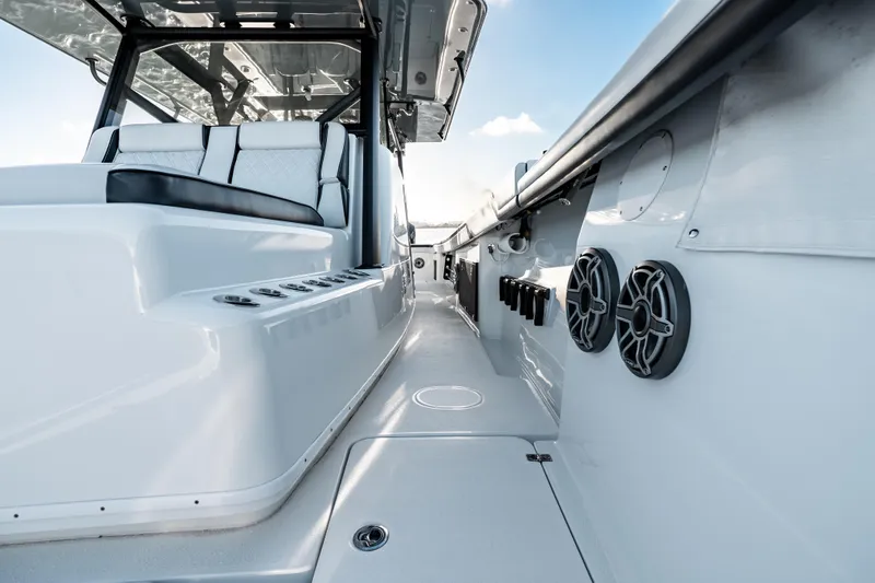  Yacht Photos Pics 2023 Yellowfin 42 Offshore boat interior with seating and speakers.