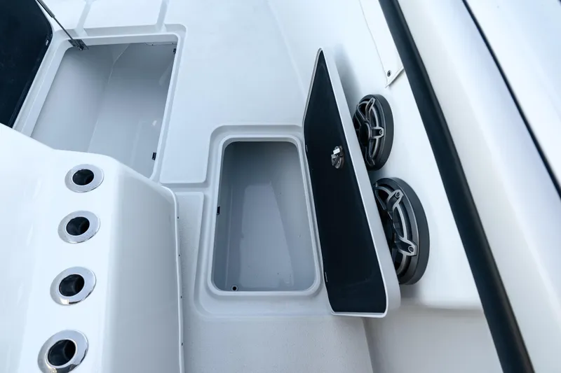  Yacht Photos Pics 2023 Yellowfin 42 Offshore boat storage compartment with open hatch and speakers.