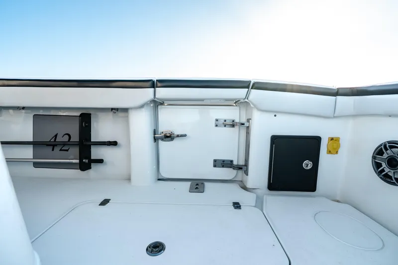  Yacht Photos Pics 2023 Yellowfin 42 Offshore boat interior with storage compartments and speaker.