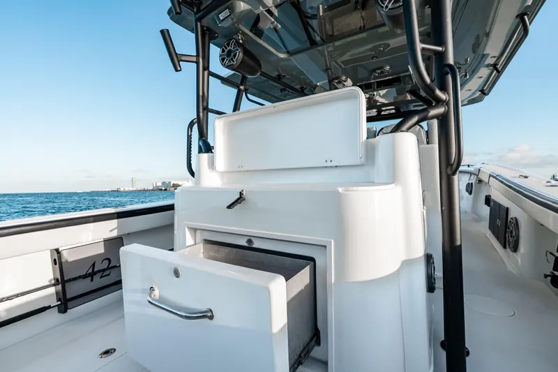  Yacht Photos Pics 2023 Yellowfin 42 Offshore boat interior with open storage compartment, ocean view.