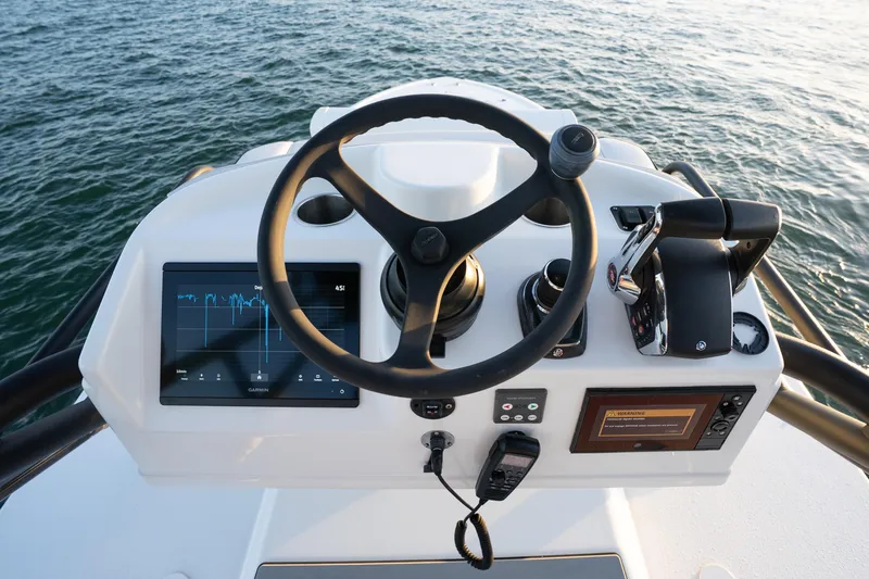  Yacht Photos Pics Helm of 2023 Yellowfin 42 Offshore boat with modern controls and navigation display.