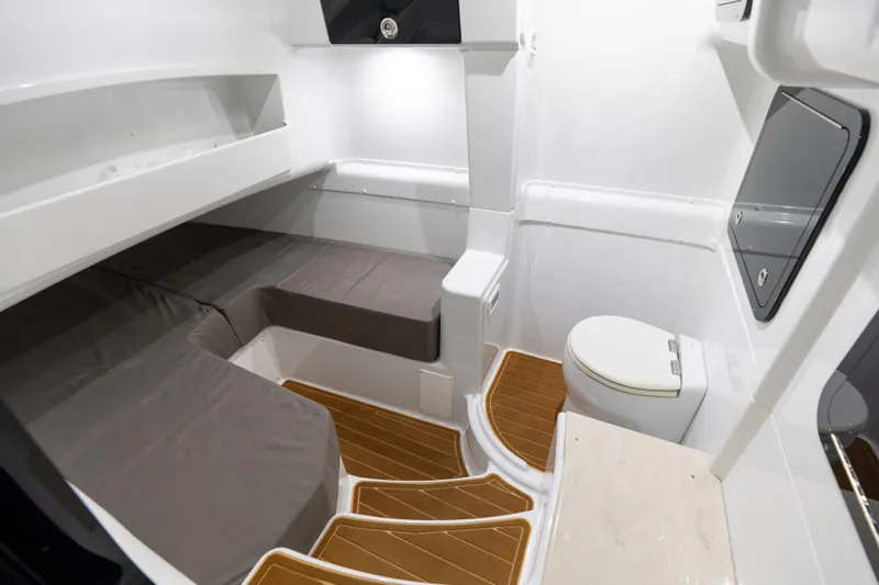  Yacht Photos Pics 2023 Yellowfin 42 Offshore cabin interior with seating and marine toilet.