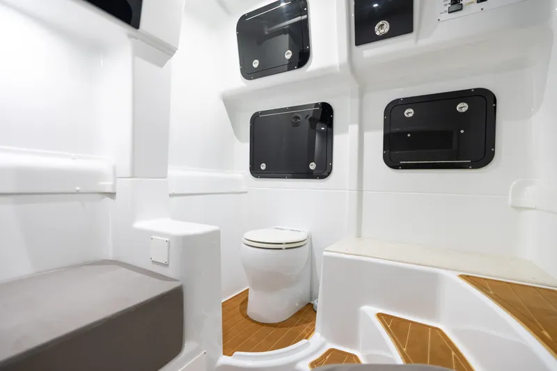  Yacht Photos Pics 2023 Yellowfin 42 Offshore boat interior with modern bathroom and storage compartments.