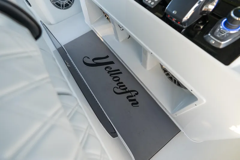  Yacht Photos Pics 2023 Yellowfin 42 Offshore boat interior with branded mat and control panel.