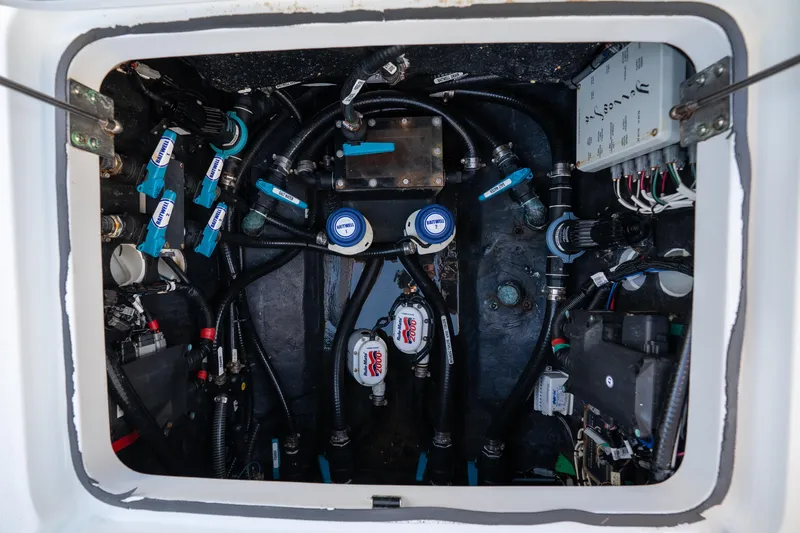  Yacht Photos Pics Engine compartment of 2023 Yellowfin 42 Offshore boat, showcasing complex wiring and plumbing.