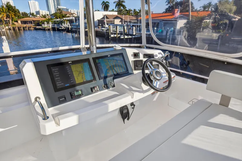  Yacht Photos Pics 2024 Leopard 46 Powercat helm with modern navigation screens and steering wheel, dockside view.