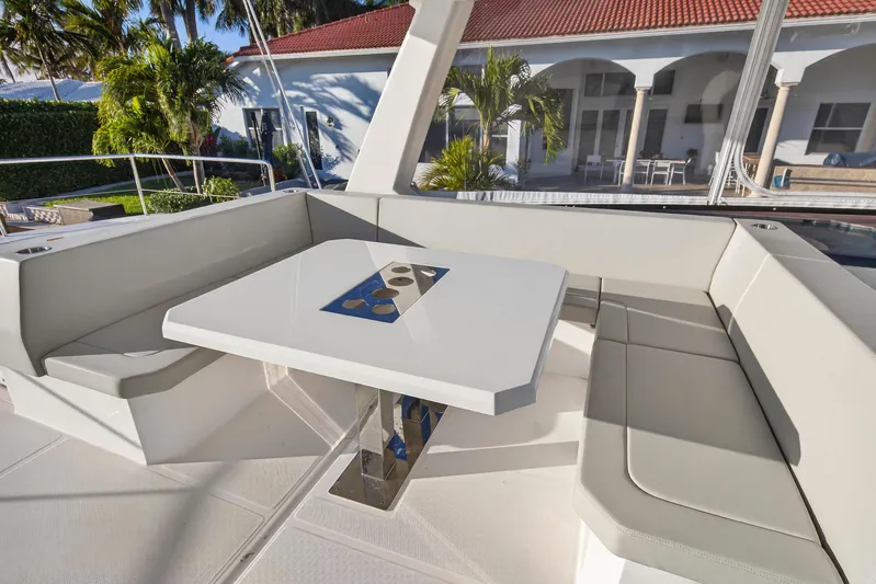  Yacht Photos Pics 2024 Leopard 46 Powercat yacht with elegant outdoor seating and table setup.