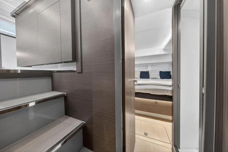  Yacht Photos Pics 2024 Leopard 46 Powercat interior with modern design, featuring stairs and a cozy bedroom.