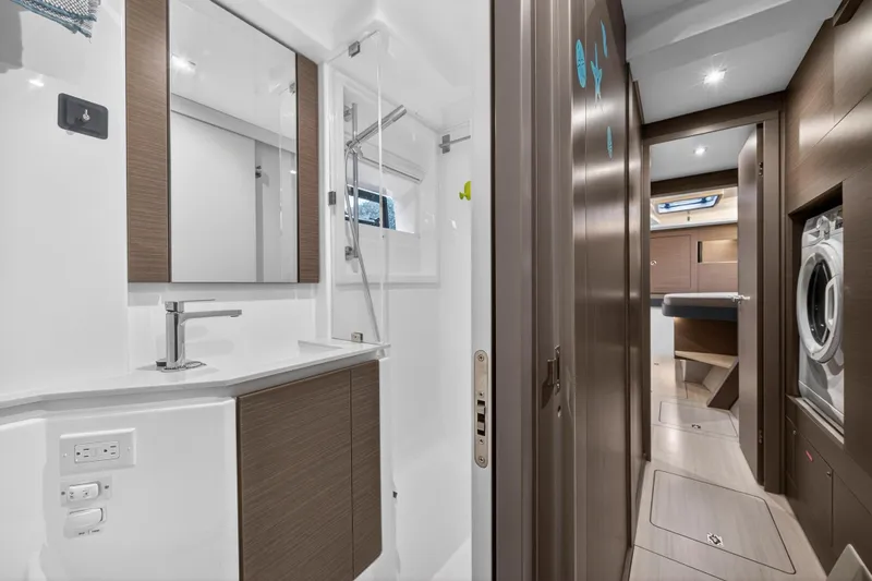  Yacht Photos Pics Luxurious bathroom and hallway in 2024 Leopard 46 Powercat yacht, featuring modern fixtures and wood accents.