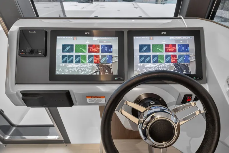  Yacht Photos Pics Helm of 2024 Leopard 46 Powercat with dual touchscreen displays and steering wheel.