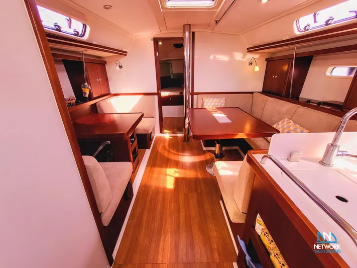  Yacht Photos Pics Interior of 2008 Hanse 400 yacht with wooden flooring and cozy seating area.