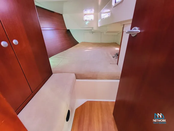  Yacht Photos Pics Interior cabin of 2008 Hanse 400 yacht with wooden finishes and cozy sleeping area.