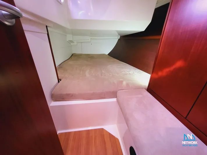  Yacht Photos Pics Cabin interior of 2008 Hanse 400 yacht with wooden finish and cozy bedding.