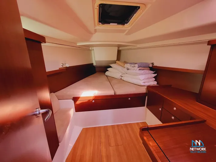  Yacht Photos Pics Cozy cabin interior of 2008 Hanse 400 yacht with wooden furnishings and bedding.
