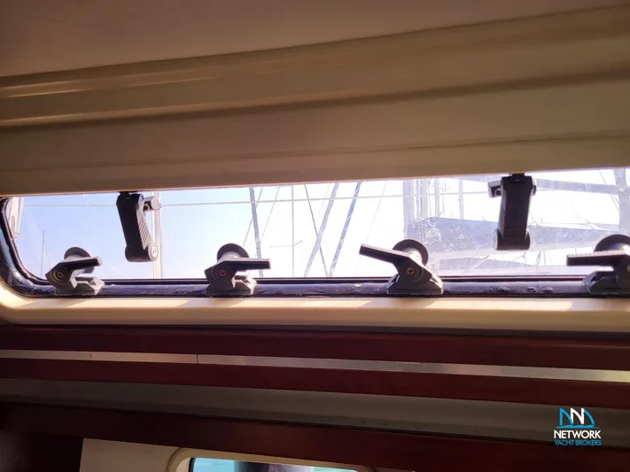  Yacht Photos Pics Interior view of a 2008 Hanse 400 yacht window with latches and exterior mast visible.