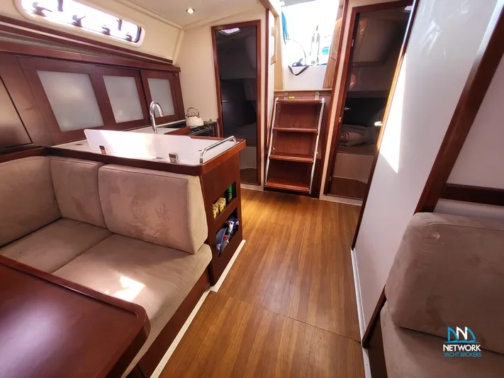  Yacht Photos Pics Interior of 2008 Hanse 400 yacht with wooden flooring and cozy seating area.