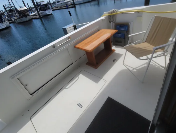 Irish Mist 11 Yacht Photos Pics 2003 Navigator 3900 Californian yacht deck with chair and table, docked at marina.