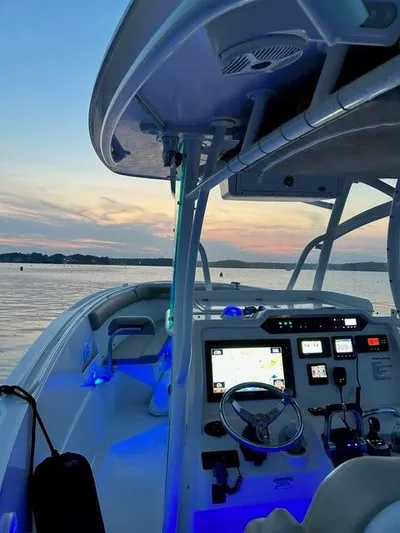  Yacht Photos Pics Sailfish 320 CC 2018 boat at sunset on calm waters.