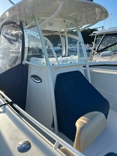  Yacht Photos Pics Sailfish 320 CC 2018 boat with blue cover in harbor.